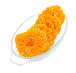 Indian Sweet Food Imarti Also Know as Amriti, Omriti, Jahangir, Jalebi, Jaangiri. It is Mde by Deep-Frying Vigna Mungo Flour Batter in a Kind of Circular Flower Shape. isolated on white Background