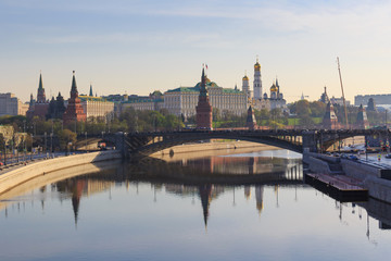 Fototapeta na wymiar Moscow Kremlin on a Moskva river embankments background. View from Patriarshiy bridge in sunny spring morning