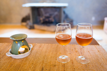 Beer glasses with aroma lamp romantic time at fireplace