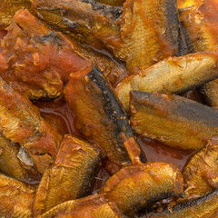 Close view of sprats in tomato sauce.