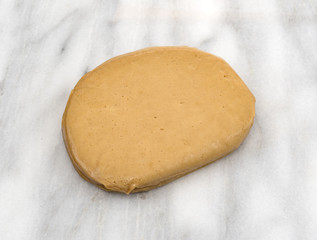 A stack of turkey flavored tofu slices on a gray marble counter top.