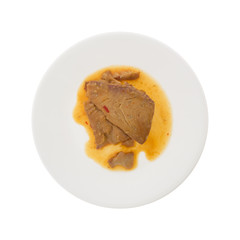 Tilapia fillet in sesame sauce on a plate isolated on a white background.