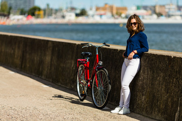 Urban biking - young woman and bike in city