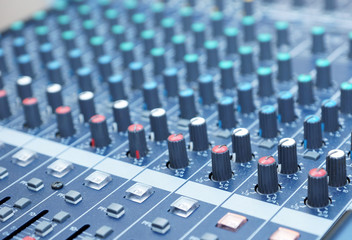 Obraz premium Professional audio mixing console. Music Studio. DJ equipment. Focus on foreground