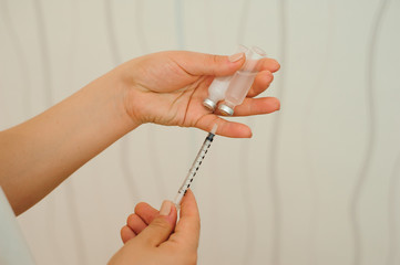 Syringe, medical injection in hand, palm or fingers. Medicine plastic vaccination equipment with needle.