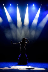 A young woman singer on stage during a concert