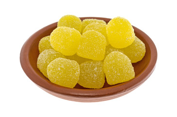 Sugar coated sour drop gummy candy in a bowl isolated on a white background.