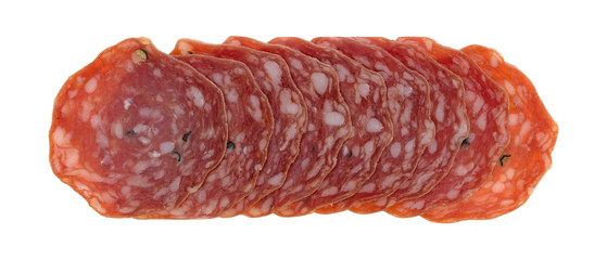 Top view of slices of uncured soppressata dry salami in a row isolated on a white background.