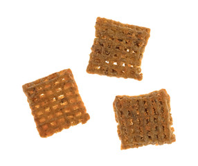 Three cheddar cheese wheat square crisps on a white background.