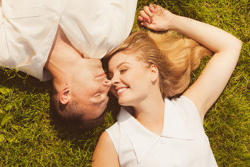Man and woman lying on grass having date