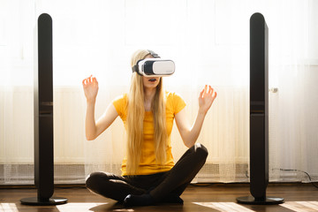 Girl wearing virtual reality goggles at home