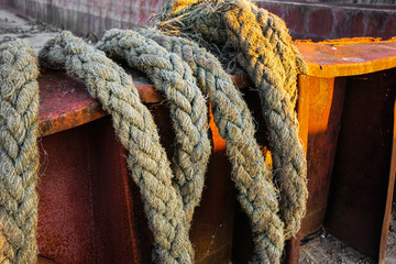 Fototapeta na wymiar thick ropes hanging on board the barge
