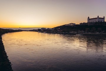 Sunset over Danube River with castle in Bratislava city, capital of Slovakia