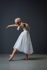 Naklejka premium Young cute ballerina dancing curving her back.