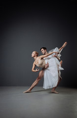 Fototapeta na wymiar Couple of dancers training and doing elegant movements.