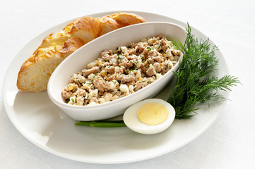 cod liver snack served with bread, egg, and fresh dill