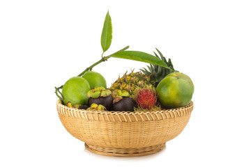 rambutan. pineapple. manggo green. orange green. mangosteen. in basket wood. isolated on white background
