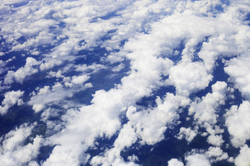 White fluffy clouds in blue sky, top view