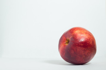 One ripe red apple on a white background