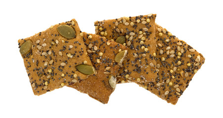 Top view of a small group of whole wheat seeded crackers on a white background.