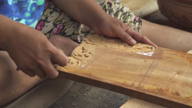 Asian wood carver working.
