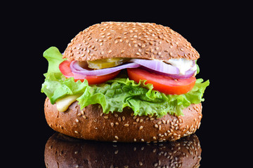 Fresh tasty burger on black background. Tasty and appetizing cheeseburger. Vegetarian burger