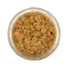 Yellow split pea and vegetable soup in an opened jar isolated on a white background.