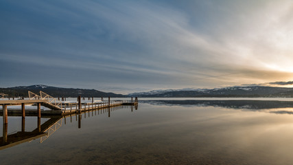 Payette Lake sunrise in winter with boat dock in McCall Idaho