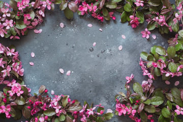 Naklejka na ściany i meble Pink flowers of blossoming fruit tree on vintage table. Copy space. View from above.