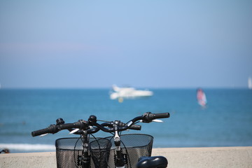 Two bicycles with a view to the mediterranean sea beach in Valencia Spain