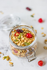 Granola in a jar with dried berries and pumpkin seeds