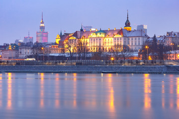 Fototapeta premium Old Town with reflection in the Vistula River during evening blue hour, Warsaw, Poland.