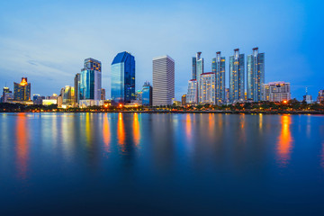 Fototapeta na wymiar Bangkok city downtown at twilight with reflection of skyline, Benjakiti Park, Bangkok,Thailand