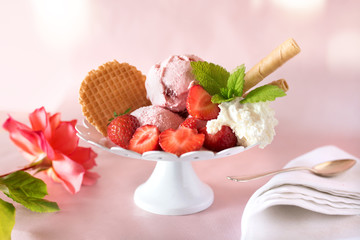 Ice cream cup with strawberries and cream