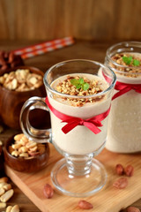 Milk protein cocktail with peanuts in a glass decorated with a red ribbon