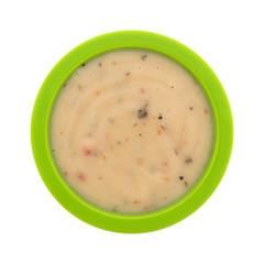 Top view of garlic and lemon marinade in a green bowl isolated on a white background.