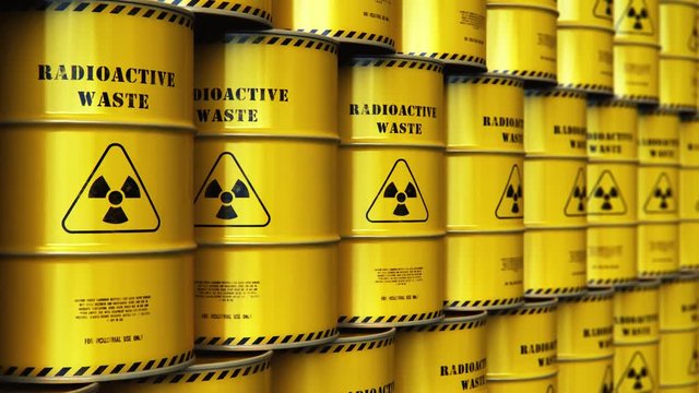 Group of stacked yellow drums with radioactive waste