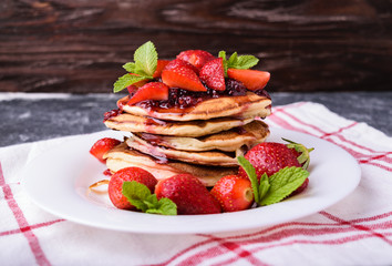 American pancakes with jam and fresh strawberries