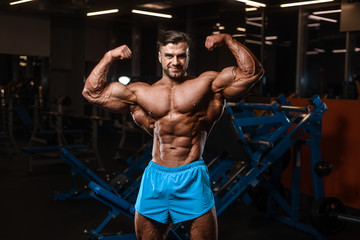 Fototapeta na wymiar Handsome model muscle man abs workout in gym