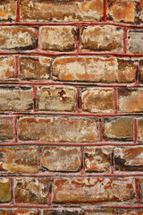 Closeup of ancient house outdoor brick wall as abstract colorful orange brown vertical  background.