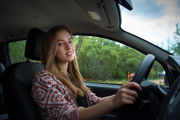 Fototapeta na wymiar beautiful girl driving a car