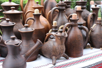 Fototapeta na wymiar Countertop with ceramic products-bottles, vases, jugs.
