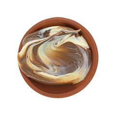 Top view of hazelnut and white chocolate spread in a small bowl isolated on a white background.