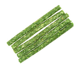 Several green dyed rawhide dog tartar sticks isolated on a white background.