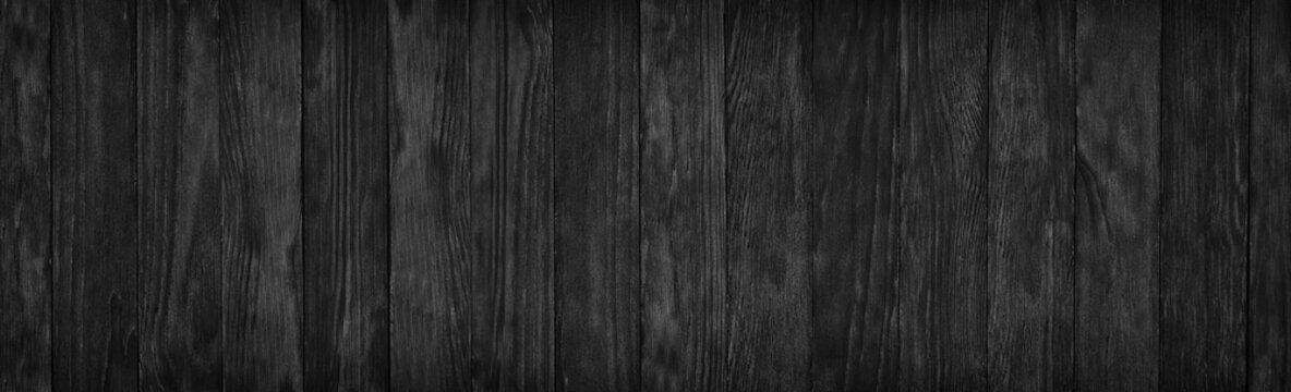 Black wood surface texture as a background, wide panorama