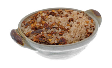 Greek spice rub in a small bowl isolated on a white background.