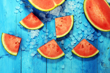 watermelon on blue background. juicy summer fruit in slices