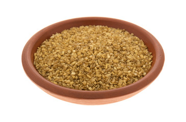 Bowl of gold sugar on a white background.