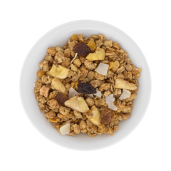 Top view of fruit mix granola in a bowl isolated on a white background.