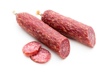 Salami smoked sausage, basil leaves and peppercorns isolated on white background.